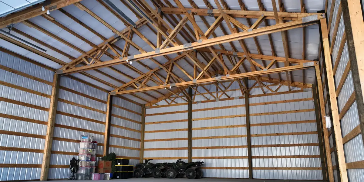 Drone view inside a finished pole barn with a galvalume roof